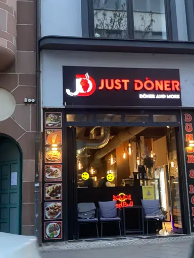 Photo of a döner-shop with the sign above the door saying "JUST DÖNER" and a smaller "döner and more" below.